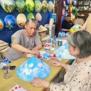 Travel group conical hat workshop in Saigon