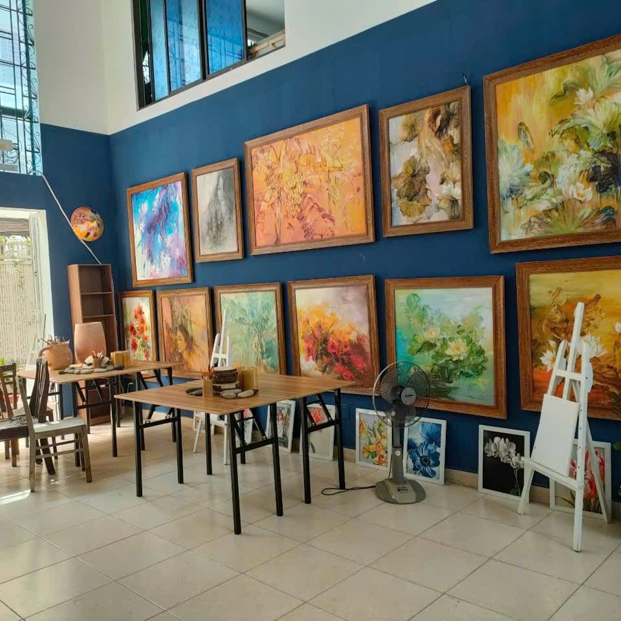 Gallery wall of custom oil paintings displayed at The Sun Art studio in Ho Chi Minh City